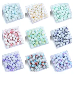 Nine colorful glass beads for DIY jewelry making displayed in clear plastic storage boxes