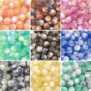Nine-grid display of assorted colorful resin cat-eye beads for DIY jewelry making