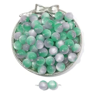Macro detail of two-tone cat eye resin beads in green and purple for DIY jewelry making