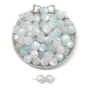 Detail of blue and pink cat eye resin beads on a silver tray for DIY jewelry making