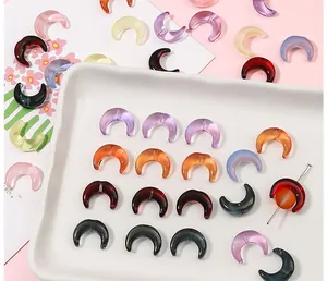 Macro shot of 15x12mm crescent moon glass beads with vertical holes for DIY jewelry