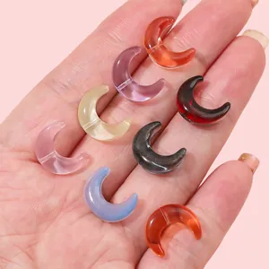 Colorful 15x12mm glass crescent moon beads held in hand for handmade DIY jewelry