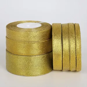 Macro shot of rolls of glitter gold metallic ribbon for DIY gift wrapping and crafts