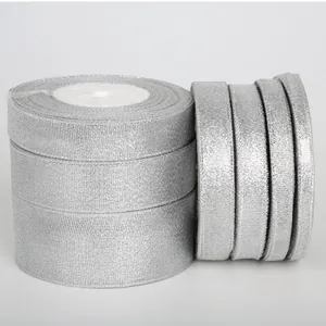 Macro detail of sparkling silver glitter ribbons rolls for gift wrapping and DIY crafts