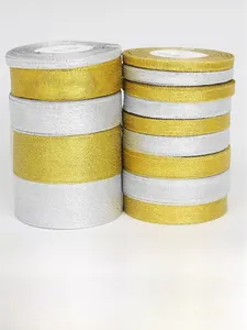 Close-up of gold and silver metallic glitter ribbon rolls for DIY gift packaging
