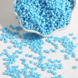 Sky blue 2-4mm glass seed beads in a white bowl for DIY bracelet and jewelry making