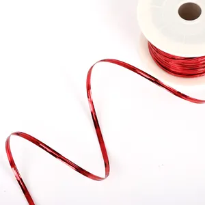 Shiny metallic red tie wire on white spool for DIY jewelry and festive gift packaging
