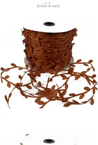 Close-up of brown artificial leaf ribbon on a white spool for DIY home decoration