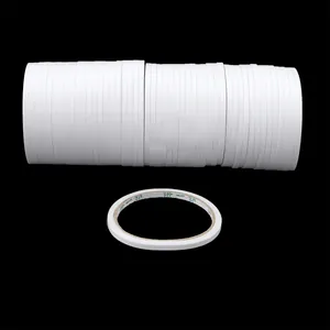 Macro shot of white high-viscosity double-sided tape rolls on a black background