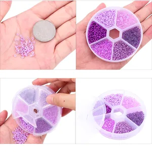 DIY purple glass seed bead kit in 7-compartment box shown with coin for scale