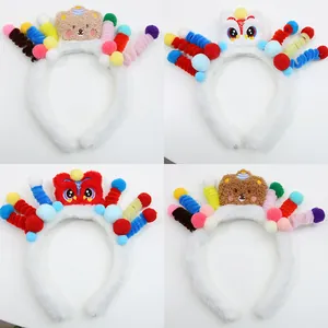 Detail view of four colorful plush headbands with cartoon bears and lion dance motifs