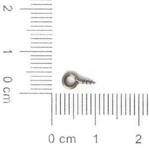 Close-up of a 10mm antique bronze screw eye pin showing precise measurements on a ruler