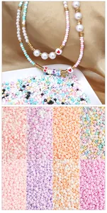 Detail of 2-3mm macaron glass beads with KISS letters and heart patterns for DIY jewelry