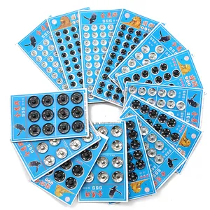 Macro display of black and silver metal snap buttons arranged on card packaging
