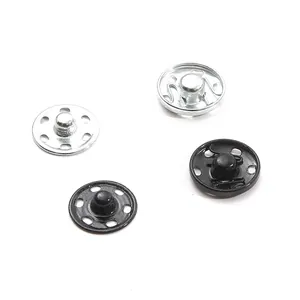Detail of metal snap fasteners in black and silver showing sewing holes and polished finish