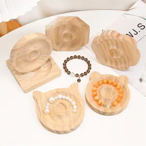 Detailed macro view of solid pine wood jewelry display trays in diverse geometric shapes