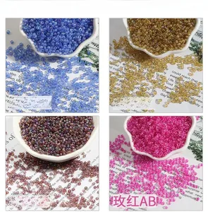 Detail of colorful AB coated glass seed beads in blue, gold, purple, and rose for DIY jewelry