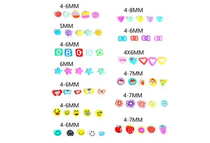 Flat lay of colorful mixed polymer clay beads for DIY crafts in fruit and heart shapes