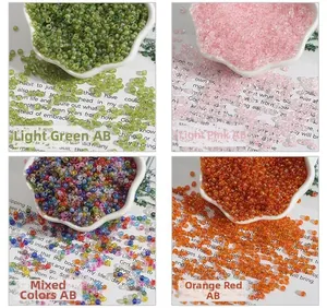 DIY glass seed beads in four colors with AB iridescent coating in white petal trays