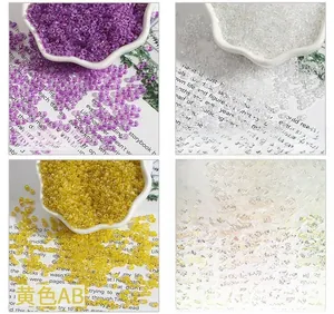 Macro detail of 2-4mm glass seed beads with iridescent AB coating in purple, white and yellow