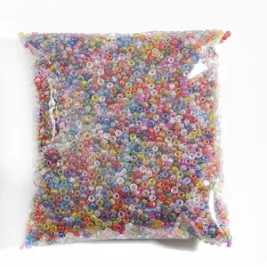 Colorful mix of small glass seed beads in a transparent bulk bag for DIY jewelry making