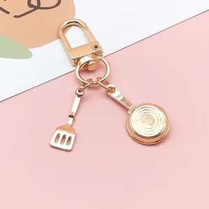 Cute golden metal kitchenware keychain with mini spatula and frying pan charms