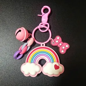 Detailed close-up of rainbow pendant with pink bell and bow keychain accessory