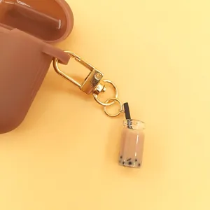 Brown silicone earphone case featuring a creative bubble tea pendant and golden carabiner