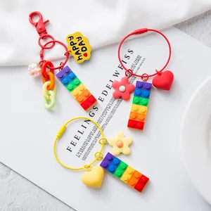 Detailed view of colorful rainbow block keychains with flower and heart charms