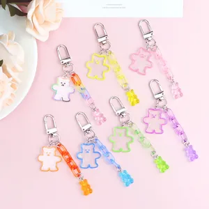 Detailed macro view of jelly-colored acrylic bear keychains with glitter and thick chains