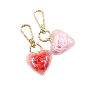 Creative heart-shaped preserved rose keychain set with red and pink flowers in gold clip