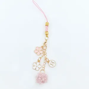 Pink floral keychain with pompom and letter H charm on gold-tone alloy chain