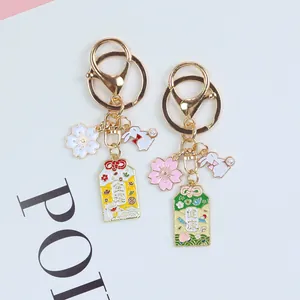 Japanese Sakura Omamori keychains for luck and health featuring enamel cherry blossoms