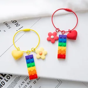 Rainbow building block keychain set with heart and flower charms on steel wire ring