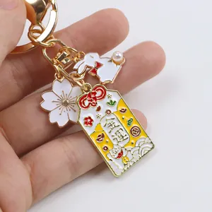 Japanese Sakura rabbit keychain with lucky charm and golden Fortune Omamori charm