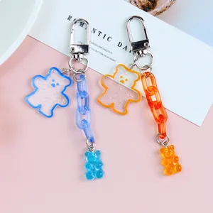 Close-up of cute jelly acrylic bear keychain with glitter details and silver clasp