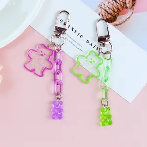 Detail of purple and green translucent jelly bear keychains with glitter and plastic chains