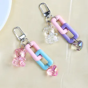 Detail of cute bear keychain charms with iridescent hearts and pastel chain links