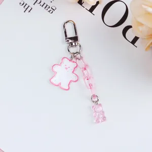 Close-up of cute pink gummy bear keychain with glitter acrylic charms and metal clasp