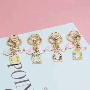 Detail of Japanese Omamori keychains with sakura and bunny charms in gold finish