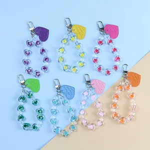 Detailed view of heart-shaped acrylic beaded keychains in seven vibrant colors