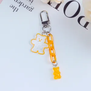 Detail of jelly bear keychain with glitter acrylic pendant and orange link chain strap