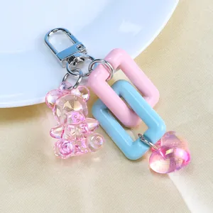 Detail of pink bear keychain with acrylic heart pendant and metal lobster clasp