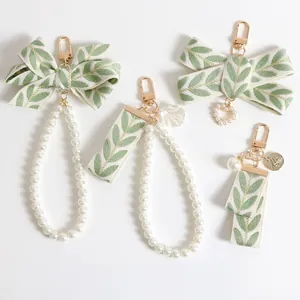 Elegant pearl bracelets with leaf print ribbons and heart shell charms for bag decoration