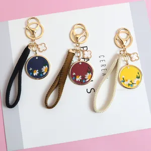 Chinese style PU leather keychain set with embroidered daisy round pendant and metal clasp