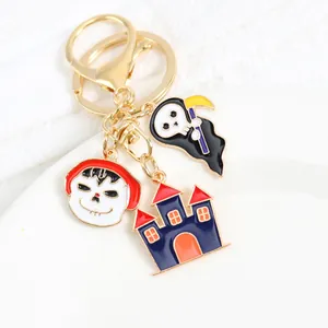 Detail of Halloween keychain charms with Grim Reaper, skull, and haunted castle metal pendants
