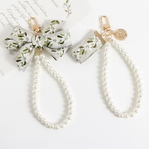 Floral embroidery keychain with faux pearl bead strand and gold coin pendant