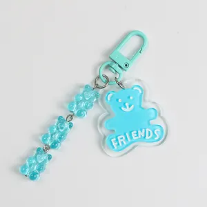 Detail of light blue bear charms with FRIENDS acrylic tag and metal lobster clasp