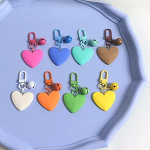 Colorful matte heart keychains with matching bells and carabiners in varied pastel colors