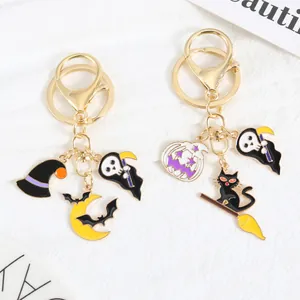 Halloween metal keychain with grim reaper, witch hat, and pumpkin in gold enamel finish